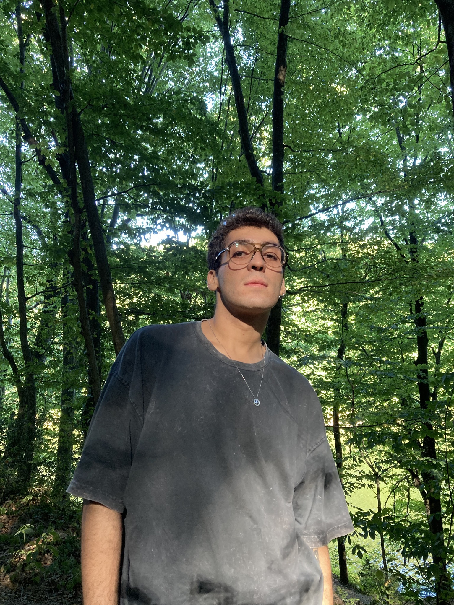 Efe Kaan Güney outdoors among the trees